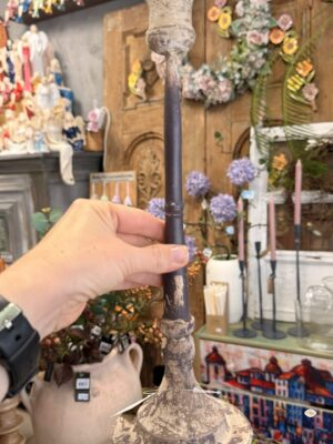 Świecznik prosty Rustic-Świecznik metalowy postarzany kremowo-grafitowy 33 cm. Metalowy świecznik o wysokości 33 cm wyróżnia się kremowo-beżowymi przetarciami na ciemnym, grafitowym tle. Smukły trzon, profilowana stopa i rozszerzona górna część nadają mu klasyczną sylwetkę z rustykalnym charakterem. Pasuje do dekoracji komody, konsoli i stołu we wnętrzach vintage, prowansalskich oraz shabby chic.